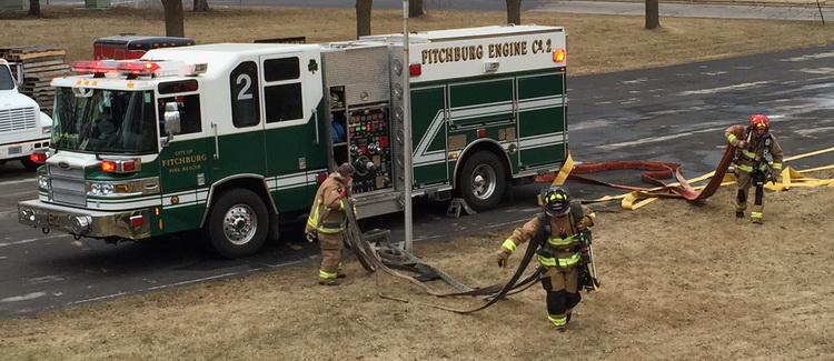 firefighters pulling hose